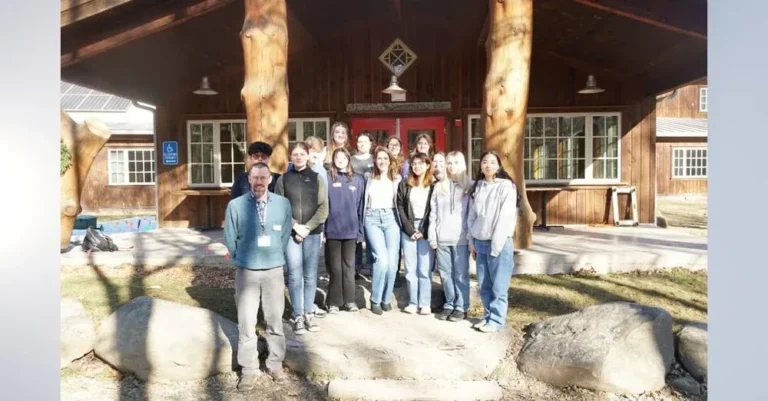 A group of students pose in front of the Ashokan Center for the YESS conference.